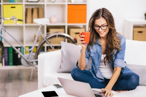 Woman Using Laptop At Home