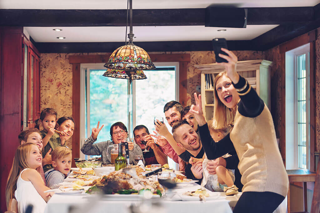 Family gathered around table for Thanksgiving