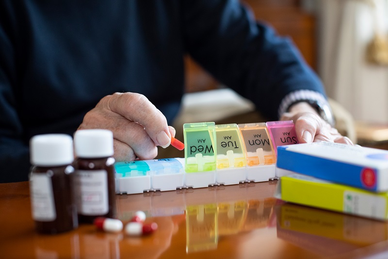 Senior Organizing Man organizing pills