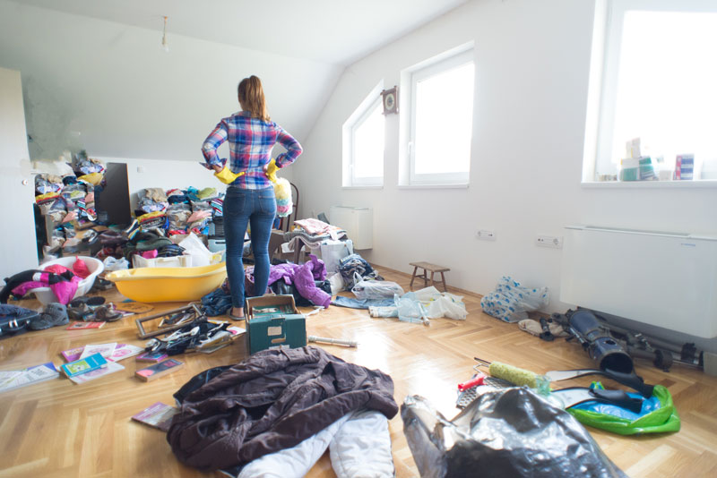woman looking at messy room