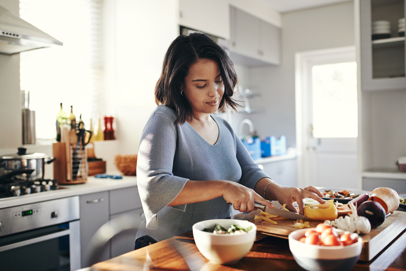 young woman cooking at home