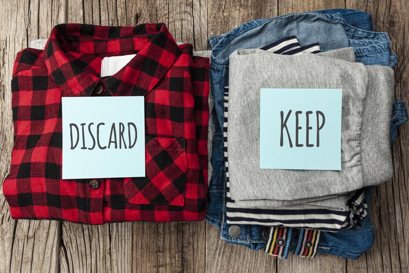 Tips to Ease The Stress Of Downsizing 4 piles of clothes for donation