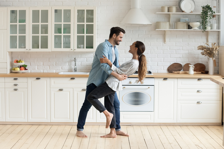 The Benefits of Organizing 5 Happy romantic couple dancing in modern kitchen at home