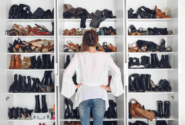 Woman cleaning shoes closet GettyImages 1216603285