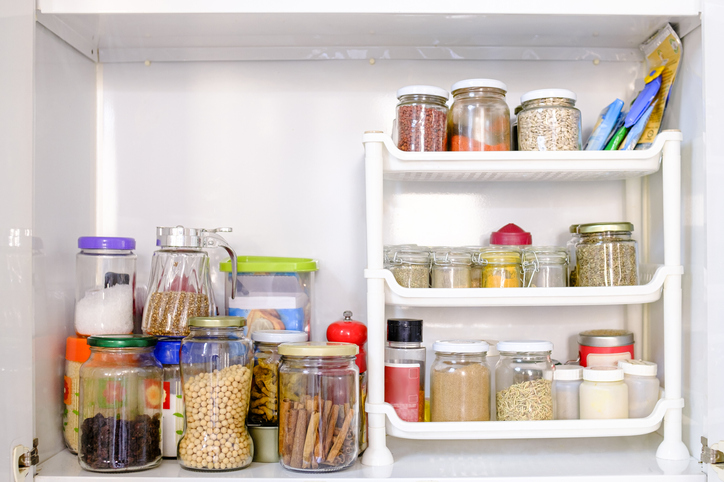 View of a well-stocked pantry with varieties of cans and pots GettyImages 1304818263